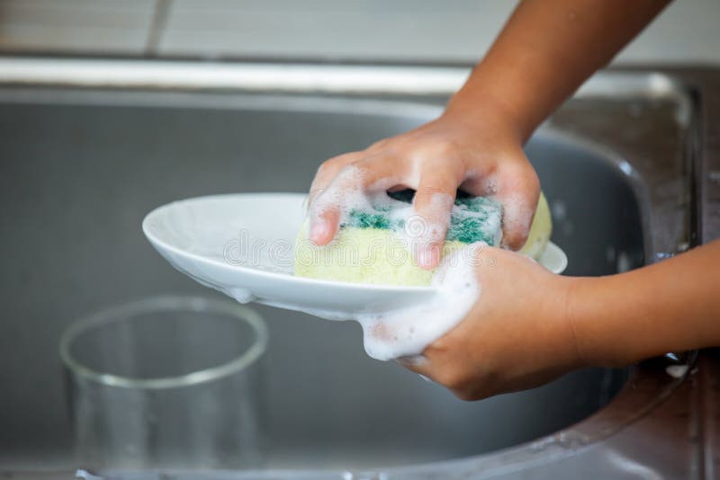 Child Hand Washing Dishes Over the Sink Stock Photo Image of