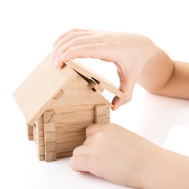 Child hands build a house