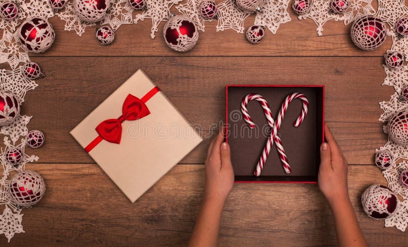 Child hands with christmas gift box containing candy canes stock image Child hands with christmas gift box containing candy canes stock image
