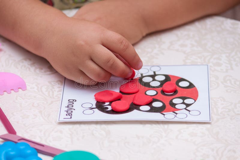 Child hands playing with colorful clay. Child play with plasticine royalty free stock image Child hands playing with colorful clay. Child play with plasticine royalty free stock image