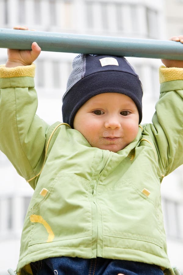 The child hanging on a horizontal bar