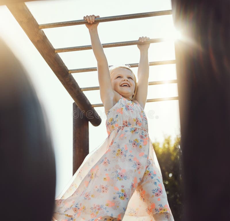 Child, happy or playing on monkey bars in park, nature garden or house backyard on holiday vacation or summer break