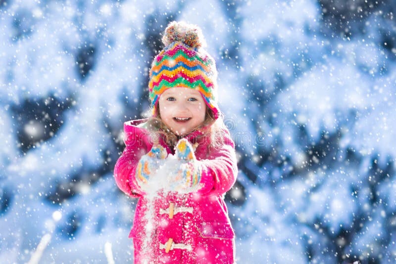 Child having fun in snowy winter park