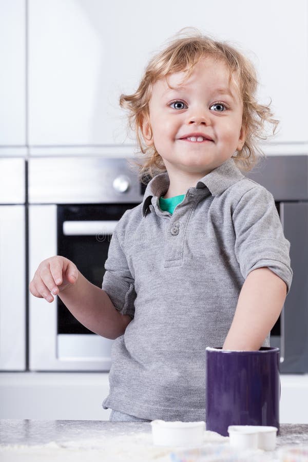 Child having good time in kitchen stock image Child having good time in kitchen stock image