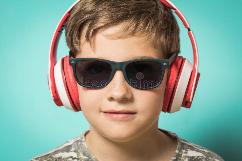 Child with headphones of music and funny expression royalty free stock photography Child with headphones of music and funny expression royalty free stock photography