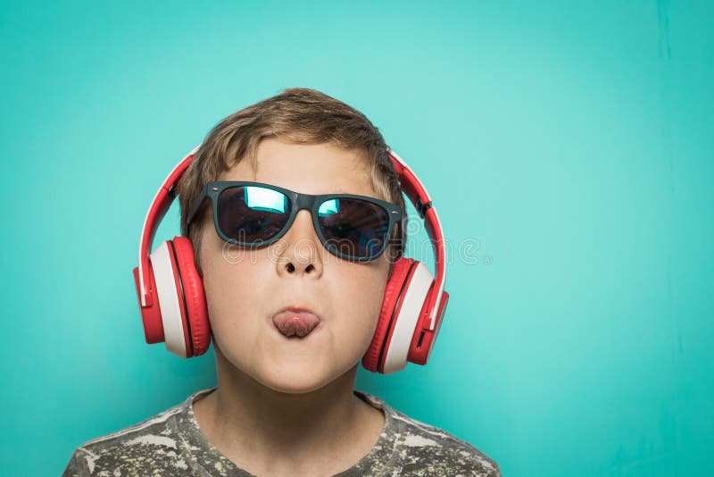 Child with headphones of music and funny expression royalty free stock photo Child with headphones of music and funny expression royalty free stock photo