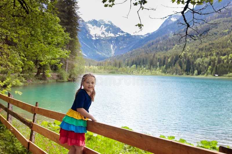 Child hiking in flower field at mountain lake royalty free stock image Child hiking in flower field at mountain lake royalty free stock image