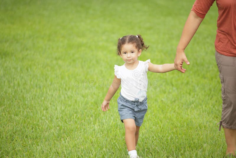 Child holding mothers hand