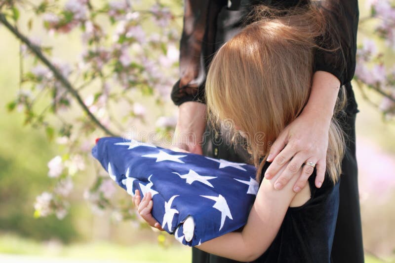 Child Holding a Parent's Folded American Flag royalty free stock photography Child Holding a Parent's Folded American Flag royalty free stock photography