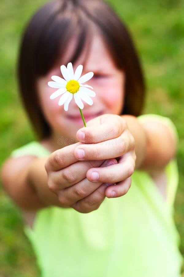 The child holds a flower