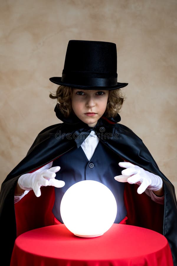 Child illusionist with magic sphere stock photo Child illusionist with magic sphere stock photo