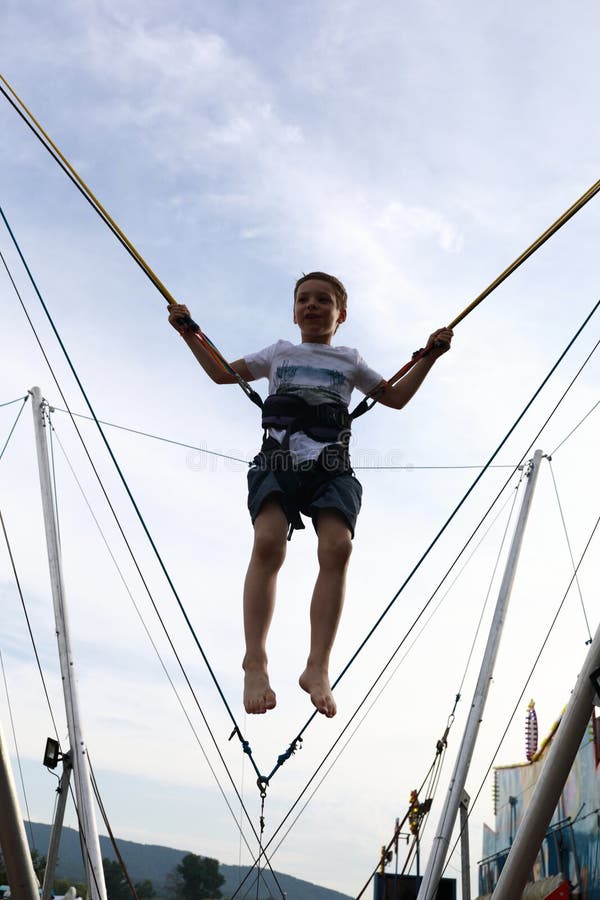 Child Jumping on Bungee Trampoline Stock Image Image of happy, leisure 157005509