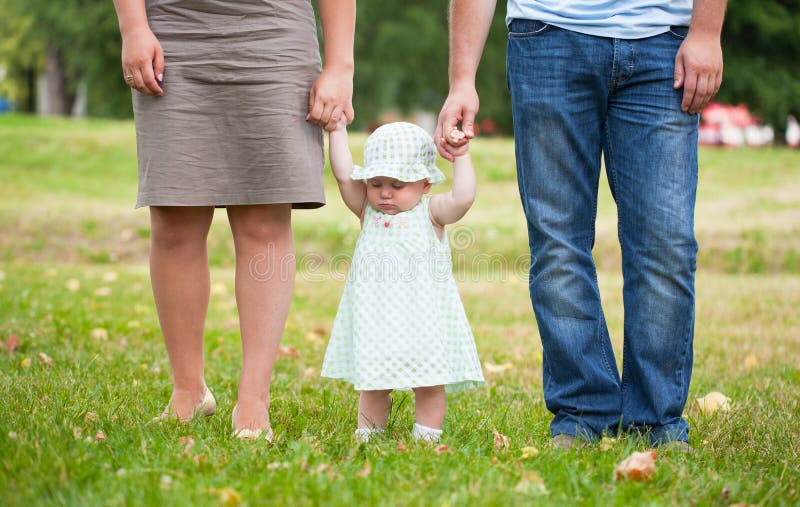 Beginning to go the child keeps for hands of parents