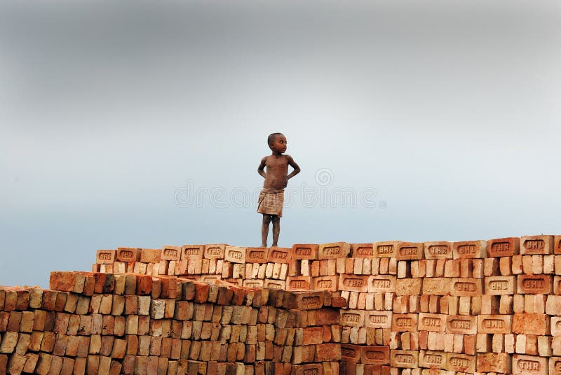 Child labour at the Indian Brick field. May 11,2011 Khariberia,West Bengal,India,Asia -A child labour on the bricks royalty free stock photography Child labour at the Indian Brick field. May 11,2011 Khariberia,West Bengal,India,Asia -A child labour on the bricks royalty free stock photography