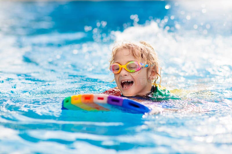 Child learning to swim. Kids in swimming pool