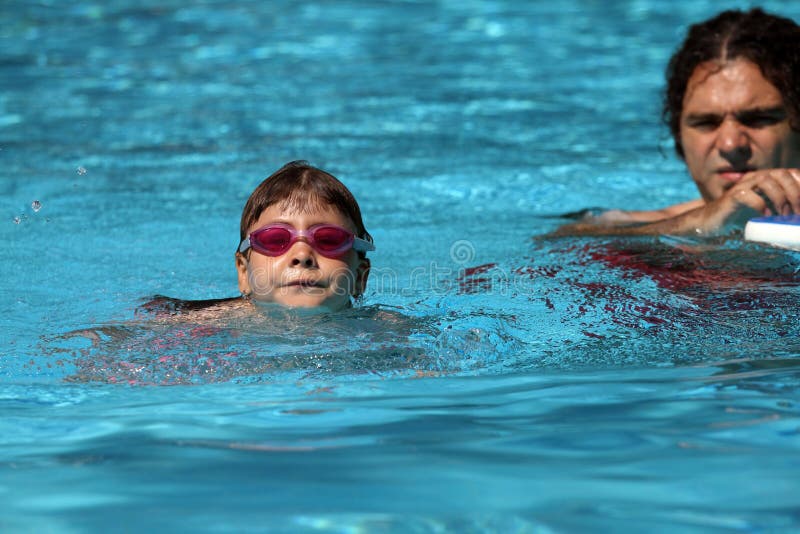 Child learning to swim, swimming lesson royalty free stock images Child learning to swim, swimming lesson royalty free stock images