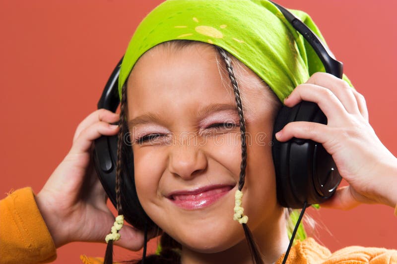 Child listening music in headphones