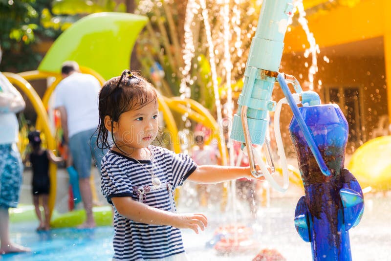 Child little girl having fun to play with water