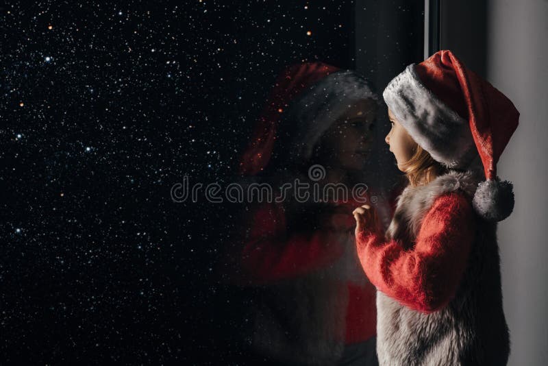 Child looks out the window on christmas of Jesus Christ