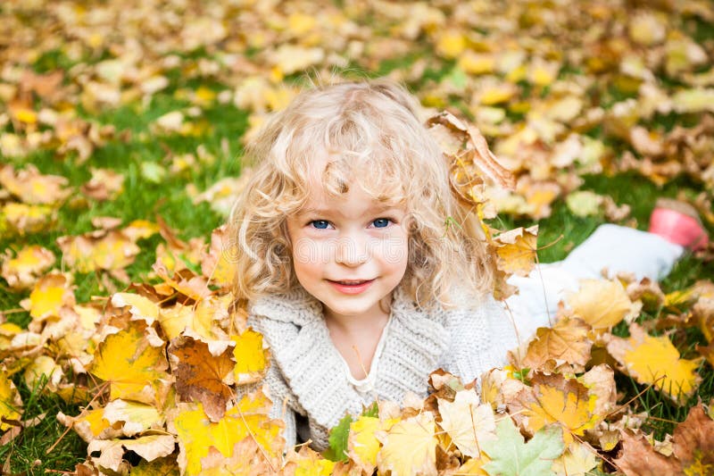 Child lying on grass stock image. Image of green, daisy - 37859007