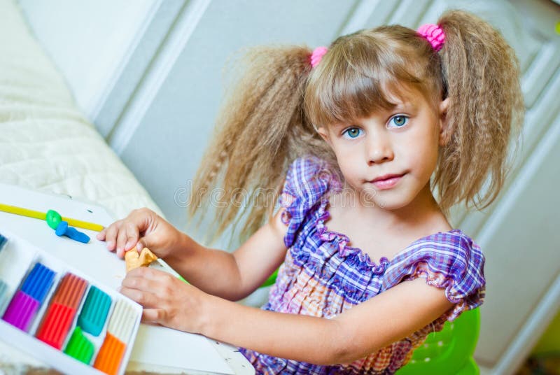 The child molds from clay royalty free stock photo