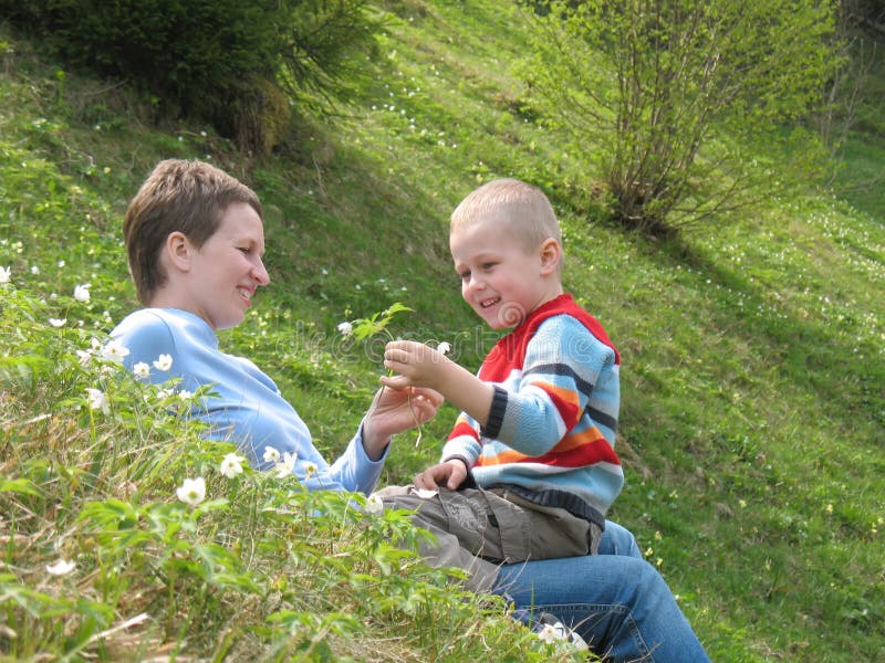 Child and mother play on grass