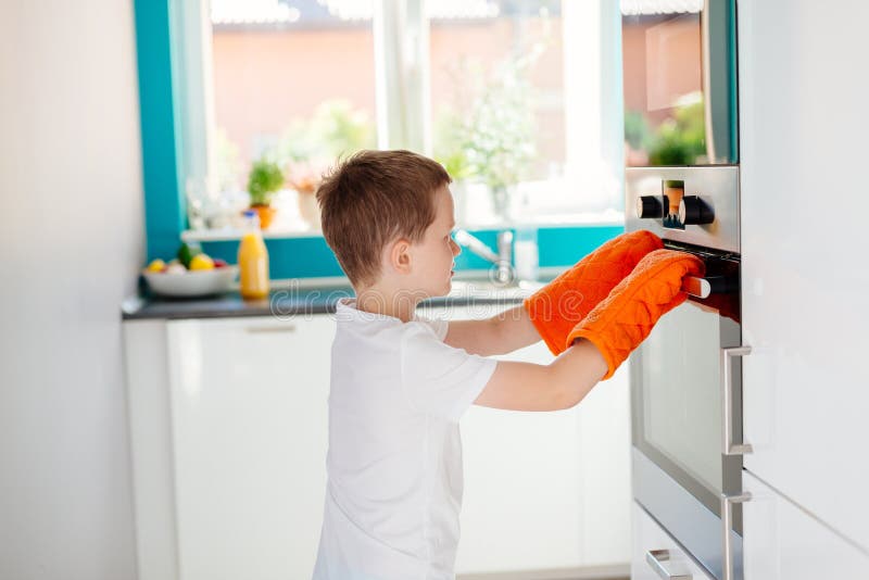 Boy looking in oven stock image. Image of child, opening 11275181