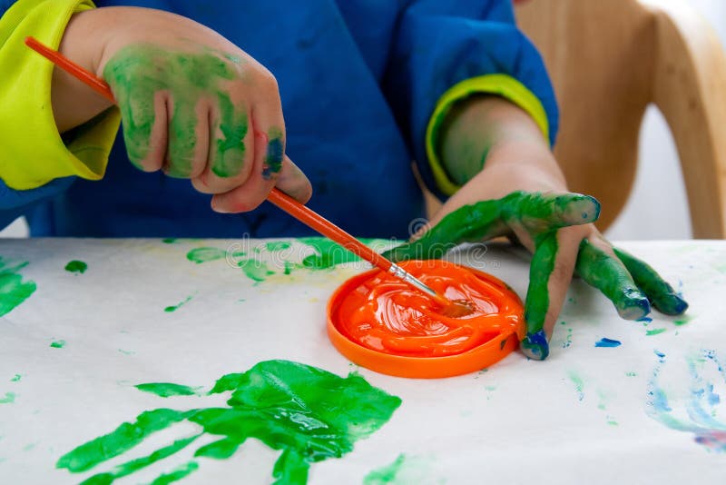 a child painting with finger paints, Stock image