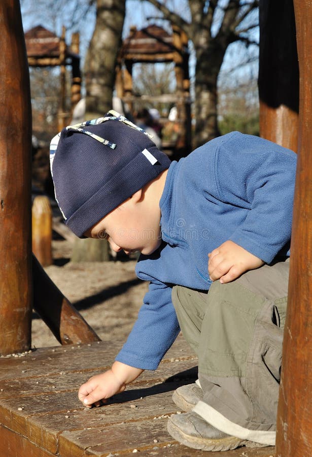 Child picking small stones