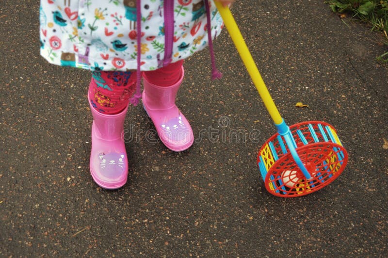 A child in pink rubber boots. rainy weather. stock photography A child in pink rubber boots. rainy weather. stock photography