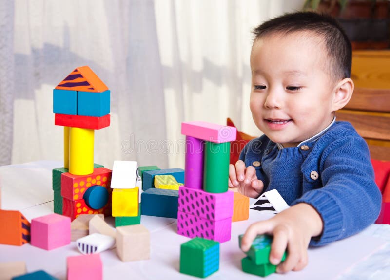 Child play with wooden blocks