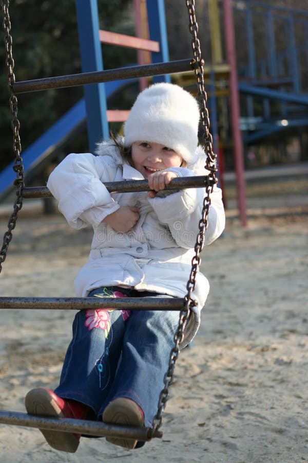 Swinging baby playground stock image. Image of playground - 12031307