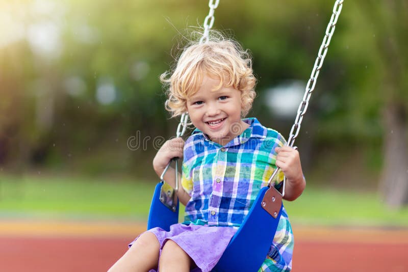 Child on playground. swing Kids play outdoor