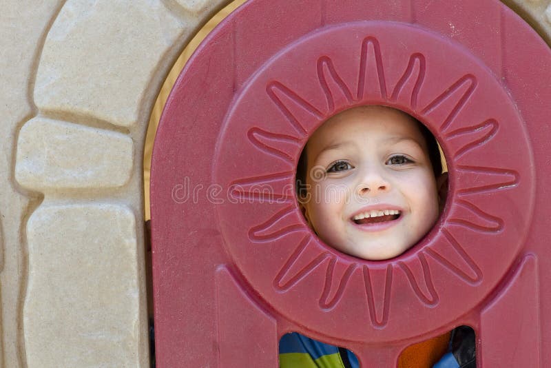 Child in playhouse window