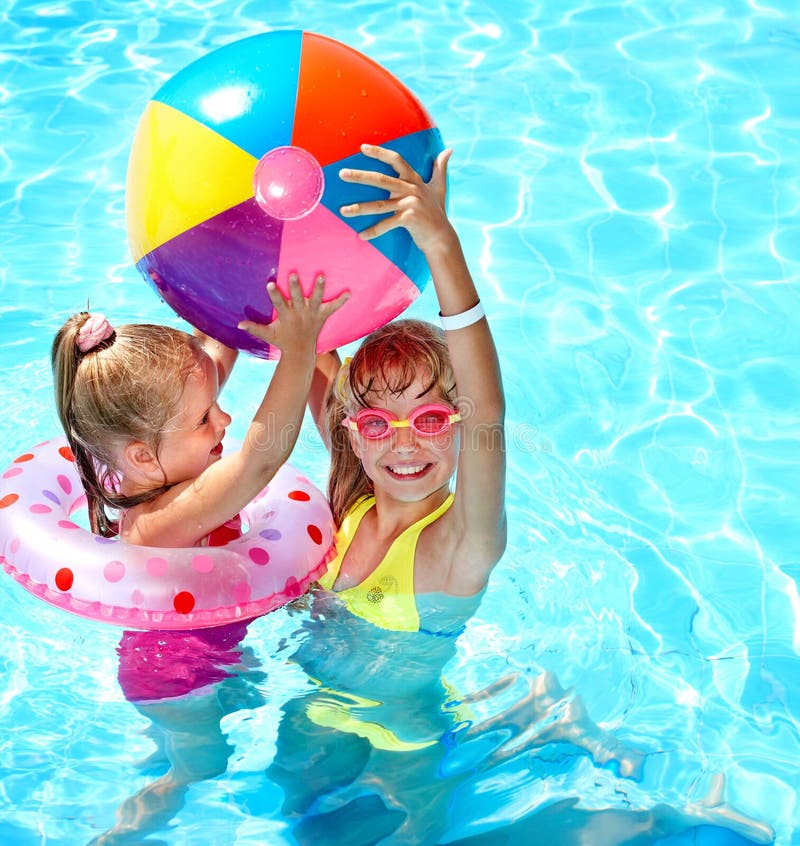 Child playing with ball in swimming pool.