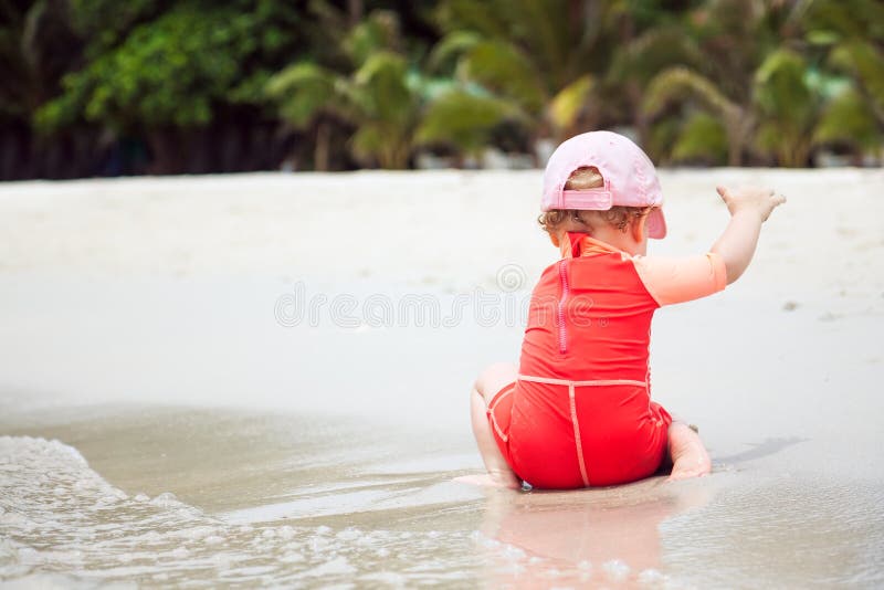 Child playing on beach with copy space during summer holidays royalty free stock images