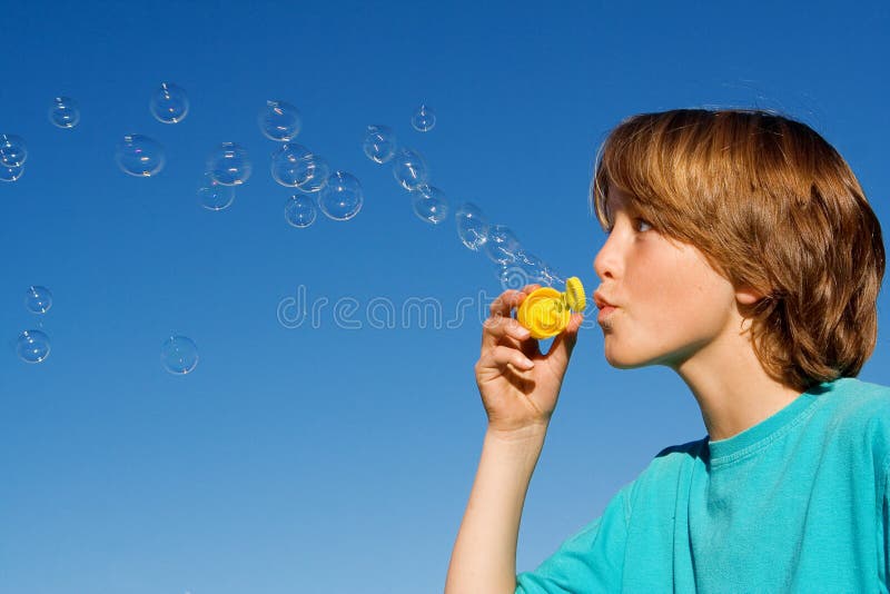 Child playing blowing bubbles