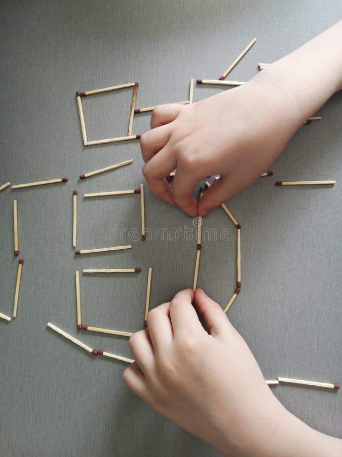 Child playing - drawing with matches