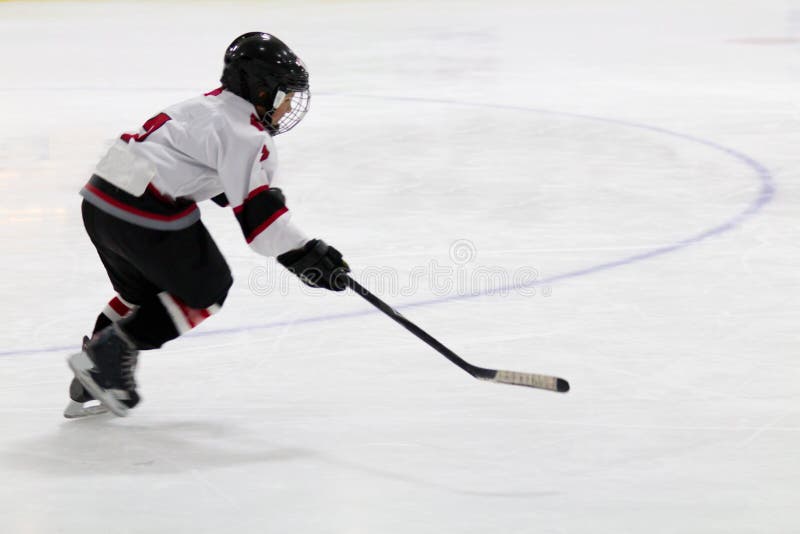 Child Skating With A Puck At Ice Hockey Practice Stock Photo Image of