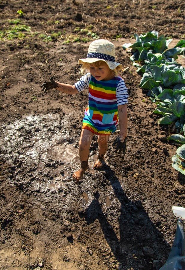 Child playing in mud. Selective focus. royalty free stock images