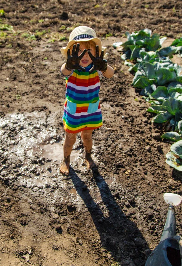 Child playing in mud. Selective focus. royalty free stock photography
