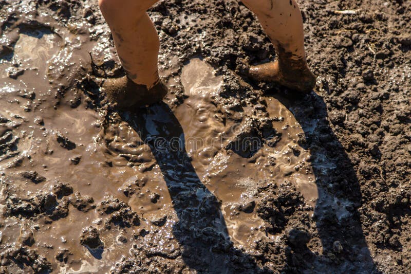 Child playing in mud. Selective focus. royalty free stock photo