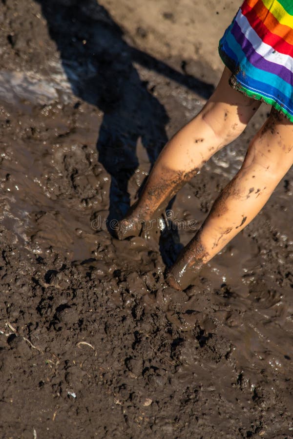 Child playing in mud. Selective focus. stock image
