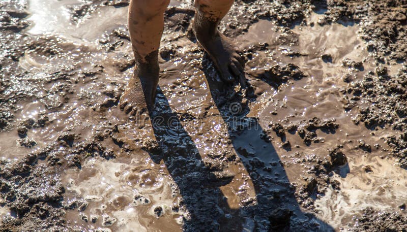Child playing in mud. Selective focus. royalty free stock photography