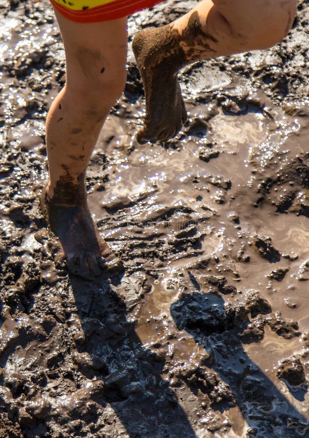 Child playing in mud. Selective focus. royalty free stock photos