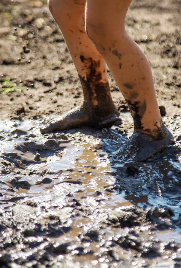 Child playing in mud. Selective focus. stock image
