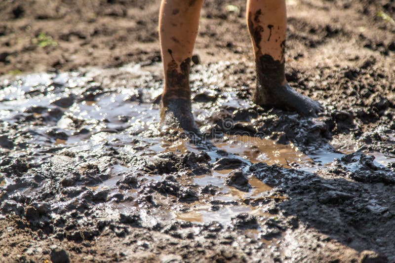 Child playing in mud. Selective focus. royalty free stock photos