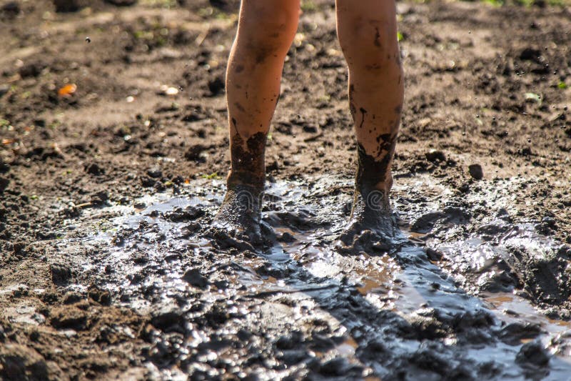 Child playing in mud. Selective focus. stock image