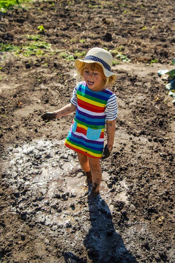 Child playing in mud. Selective focus. royalty free stock photography