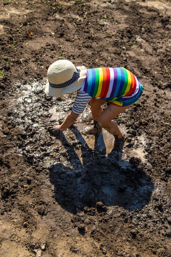 Child playing in mud. Selective focus. royalty free stock photo